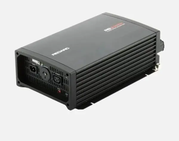 A black power inverter is sitting on top of the floor.