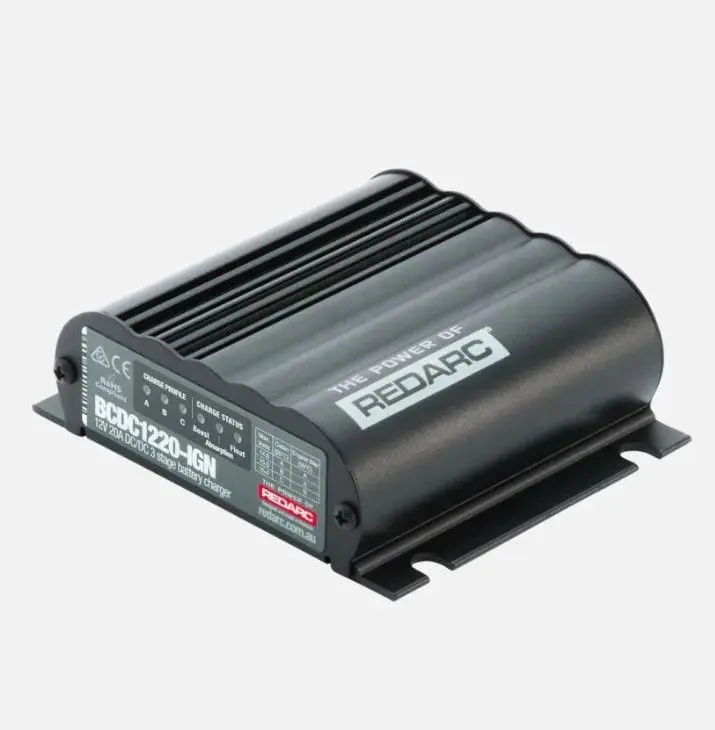 A black box with a red button on top of it.