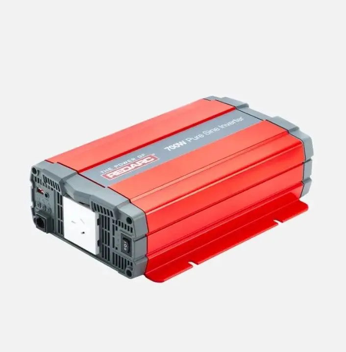 A red and gray power inverter is on the ground