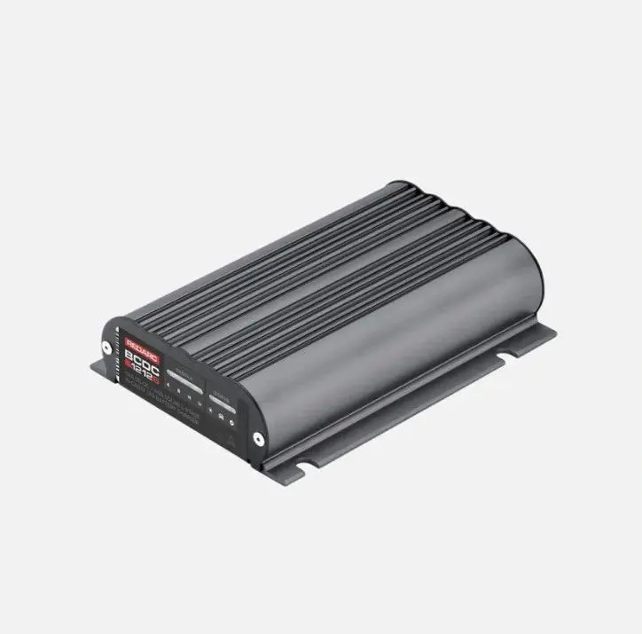 A black and silver car charger on top of a white wall.