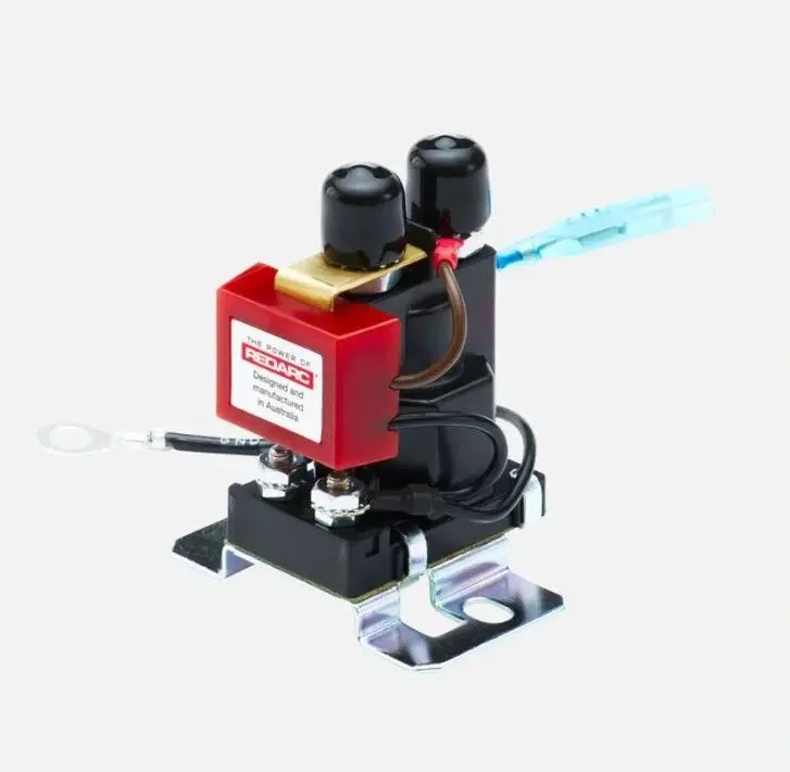 A red and black machine with wires attached to it.